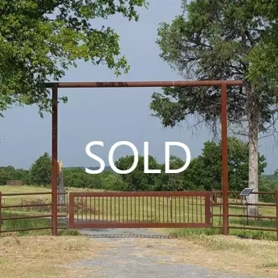 vacant lot with SOLD sign